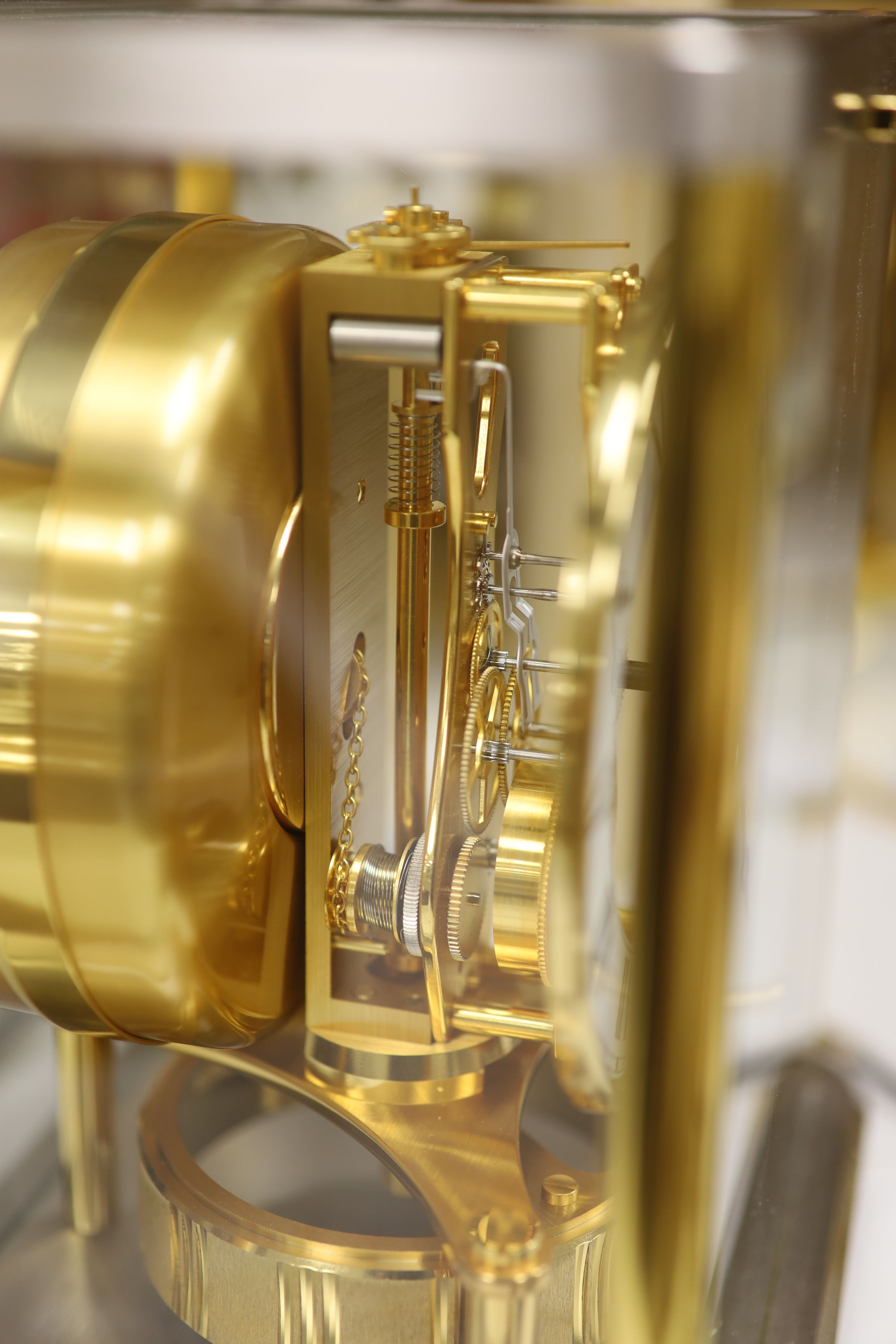 A Jaeger le Coultre Atmos mantel clock, in silvered and gilt metal glazed panelled case, height 23cm